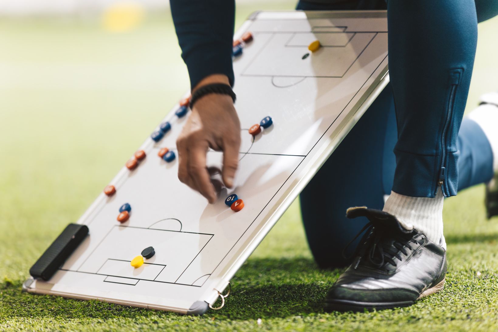 Football Coach Using Soccer Tactics Strategy Board. Coach Explai